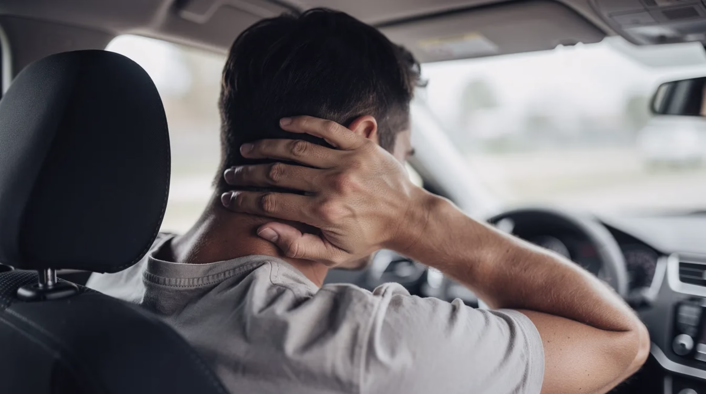 Man Grabbing At Neck in Car Due to Car Accident Man Grabbing At Neck in Car Due to Car Accident